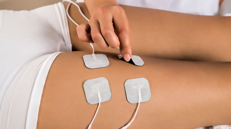 Female Athlete with Electrical Muscle Stimulator