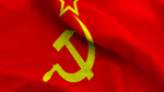 A red flag with a yellow hammer and sickle emblem, topped with a star, representing the Soviet Union, seems to flutter like high-speed running in a gentle breeze.