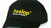 A black baseball cap features freelap and freedom of timing elegantly stitched in yellow and white text on the front, capturing a sense of privacy policy awareness.