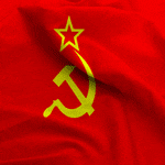 A red flag with a yellow hammer and sickle emblem, topped with a star, representing the Soviet Union, seems to flutter like high-speed running in a gentle breeze.