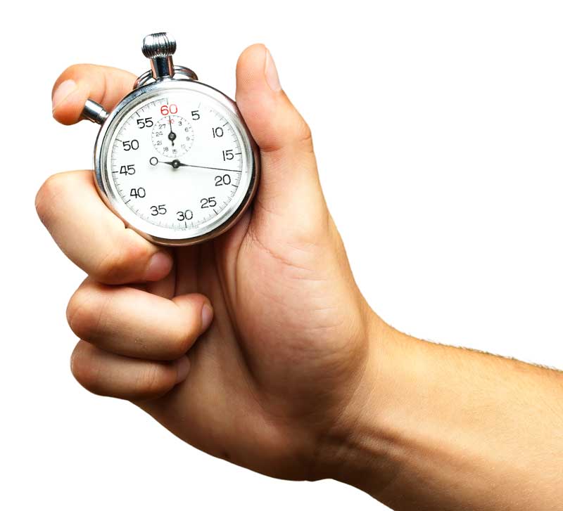 A hand holding a silver stopwatch against a white background, showcasing precision in electronic timing as the second hand approaches the 60-second mark.